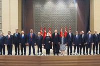 President Recep Tayyip Erdou011fan (C), poses with the members of the newly appointed Cabinet following a news conference at the Beu015ftepe Presidential Complex in Ankara, July 9.