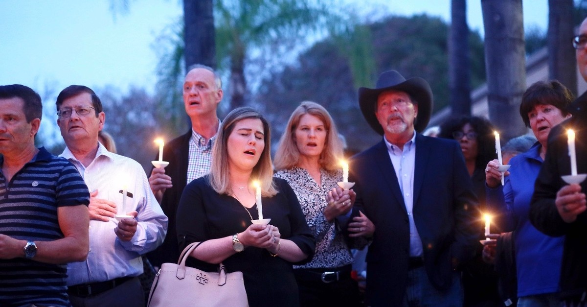 Mourners, including Poway Mayor Steve Vaus (1st right) participate in a candlelight vigil for the victims of the Chabad of Poway Synagogue, Poway, California, April 27, 2019. 