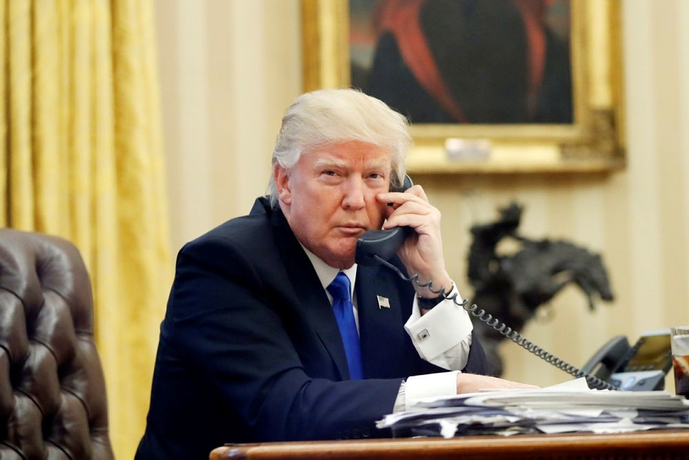 Donald Trump speaks on the phone with Prime Minister of Australia Malcolm Turnbull in the Oval Office of the White House in Washington. (AP Photo)