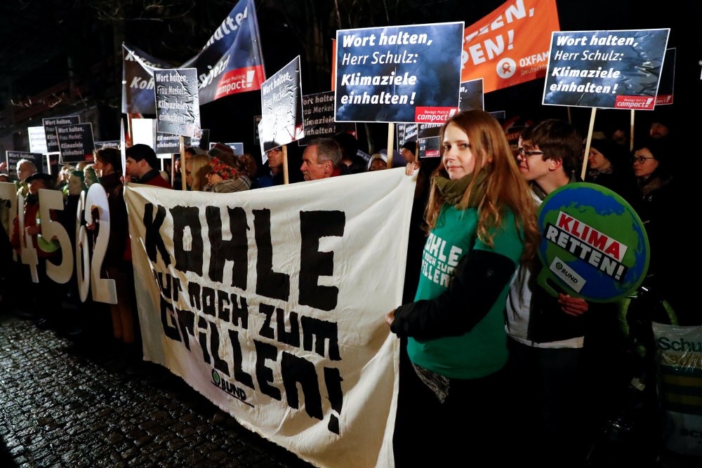 Campact environmental activists hold a banner that reads ,Coal just for barbecue, during a protest to support the German climate targets for 2020 in Berlin.
