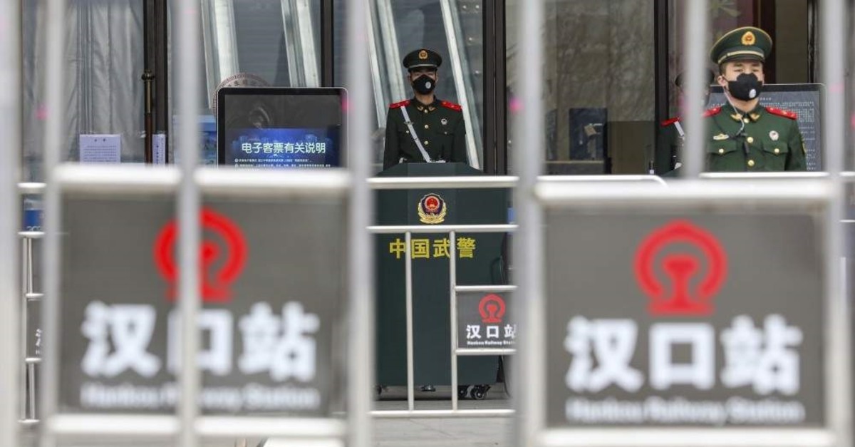 In this Thursday, Jan. 23, 2020, file photo, Chinese paramilitary police stand guard outside the closed Hankou Railway Station in Wuhan in central China's Hubei Province. (Chinatopix via AP)