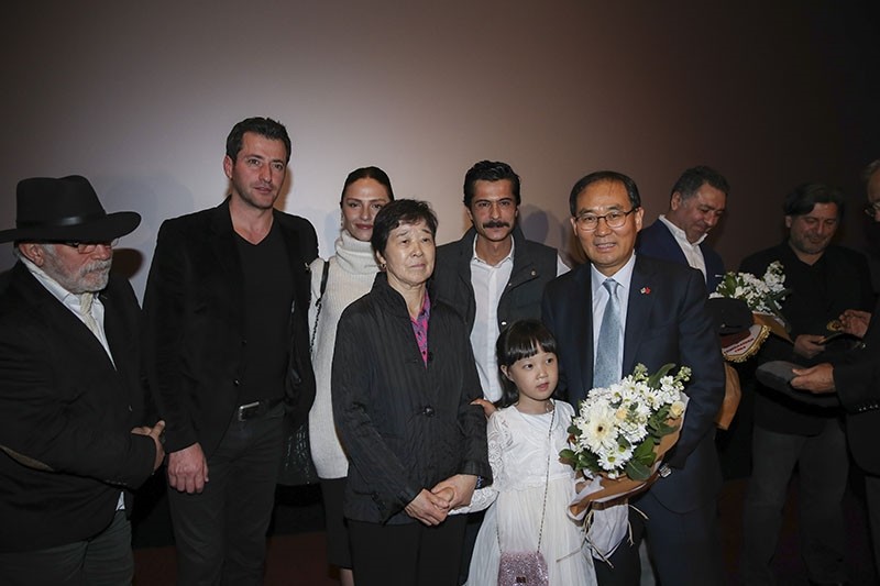 South Korean Ambassador Yunsoo Cho presents flowers to the crew of Ayla during the special screening of the movie in Ankara, on Nov. 18, 2017. (AA Photo)