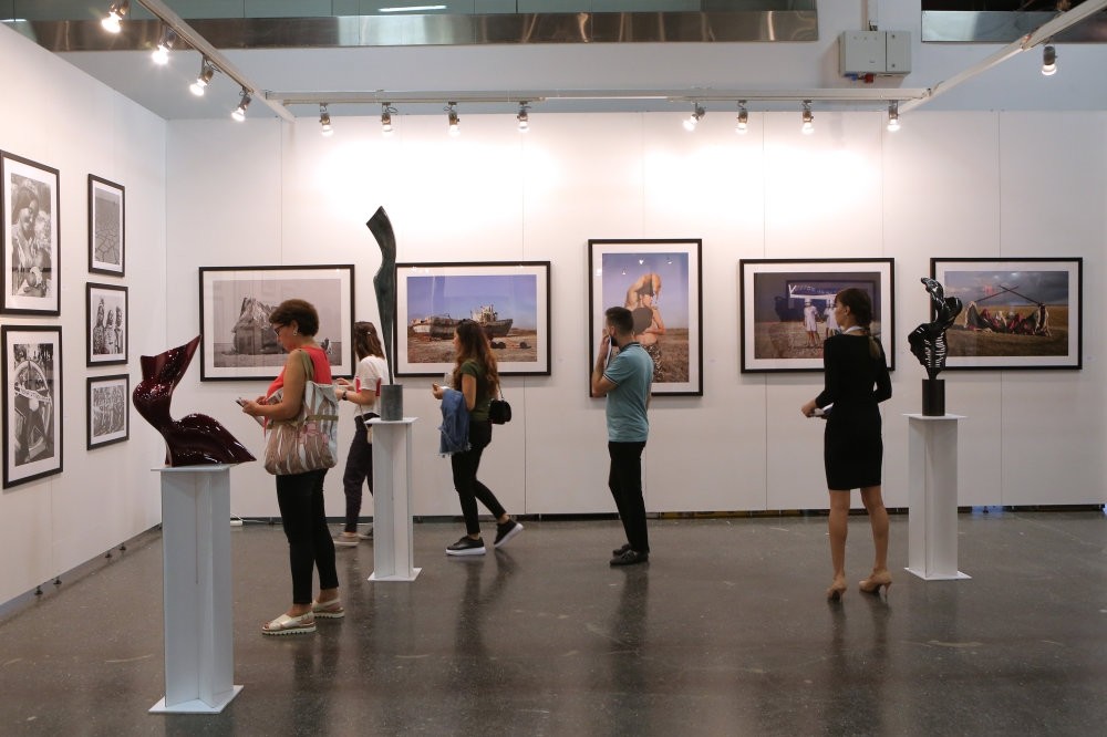 People visit an exhibition at the Contemporary Istanbul art fair, u015eiu015fli, Istanbul.