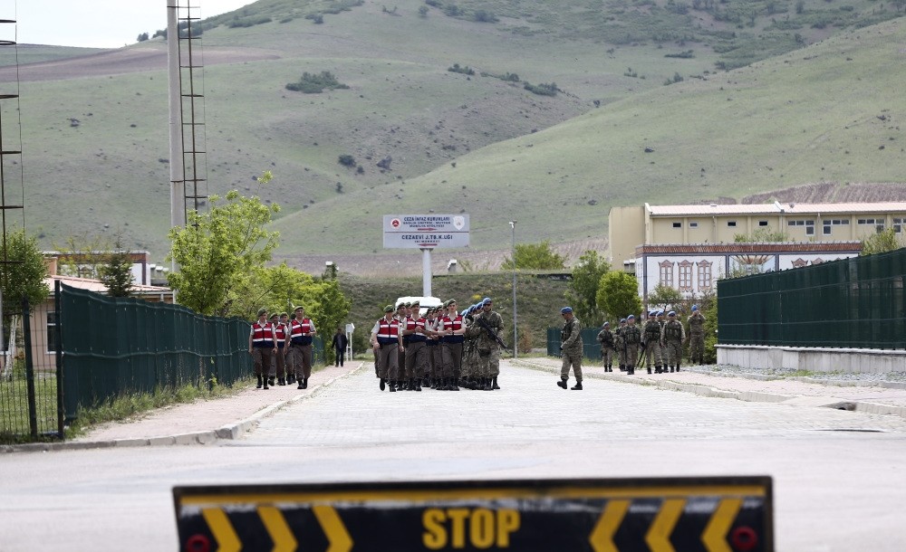 Officers inspect gendarmerie commandos at the complex housing a courtroom and prison where coup suspects are being held ahead of today's trial.