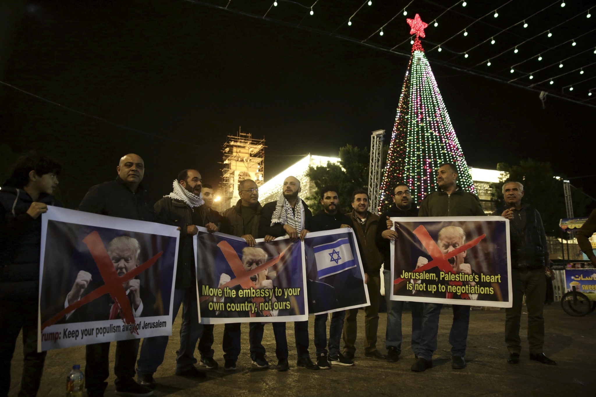 Palestinians hold posters of the U.S. President Donald Trump during a protest in Bethlehem, West Bank, Tuesday, Dec. 6, 2017. (AP Photo)