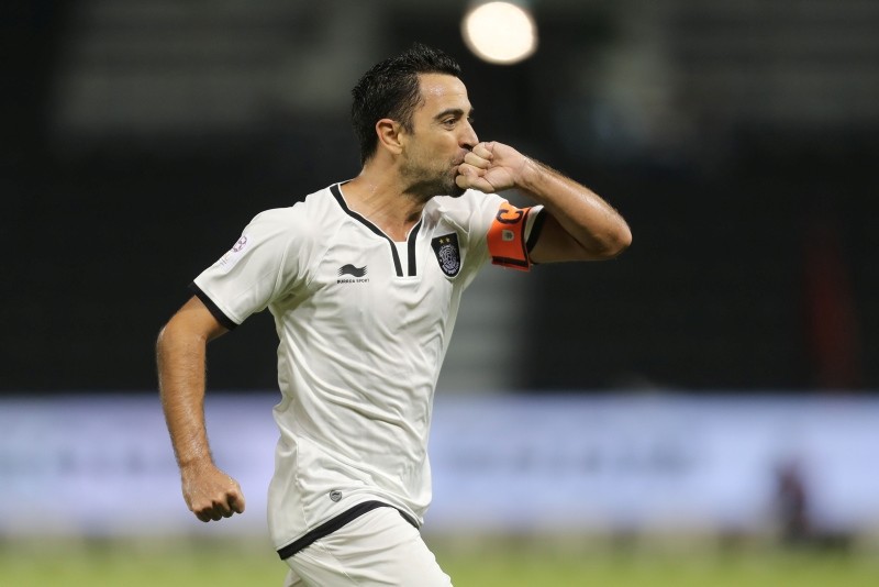 Qatari Al-Sadd club's Xavi Hernandez celebrates scoring a goal against Al-Rayyan's team during their Qatar Stars League football match at the Jassim Bin Hamad stadium in Doha. (AFP Photo)