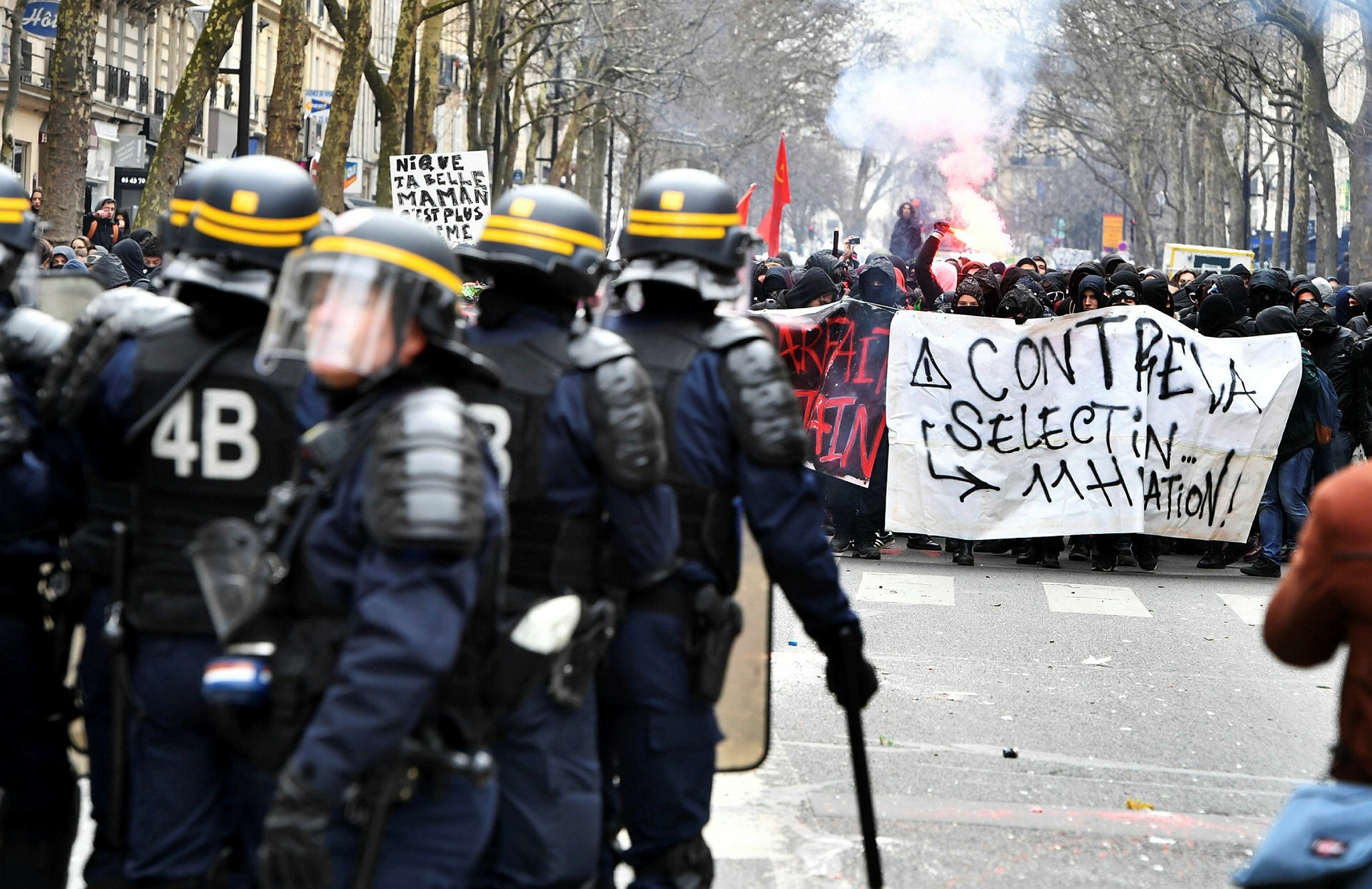 Students face riot police during a demonstration as part of a nationwide day of protest against the French president, March 22.