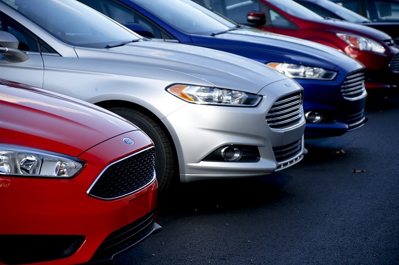 In this Nov. 19, 2015, photo, a row of new Ford Fusions are for sale on the lot at Butler County Ford in Butler, Pa. (AP Photo)