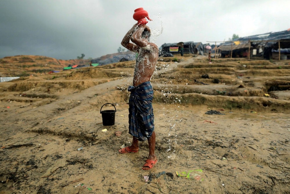 A male Rohingya refugee washes in a refugee camp in the Palong Khali district, Bangladesh, Oct. 12.