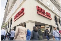Pedestrians pass a Rite Aid store in Oakland, California, U.S., April 1, 2015.