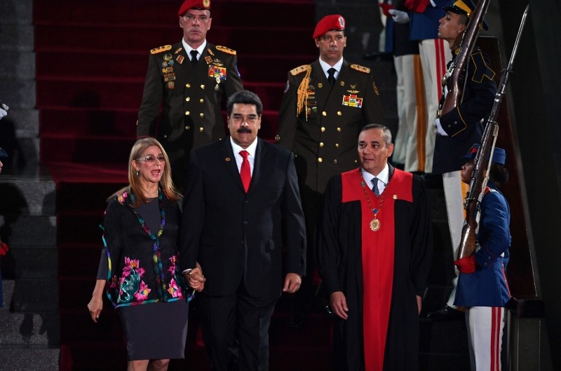 Venezuela's President Nicolas Maduro (C) walks flanked by First Lady Cilia Flores and the president of the  Supreme Court of Justice (TSJ) Maikel Moreno (R) upon arrival for the inauguration ceremony of his second mandate (AFP Photo)