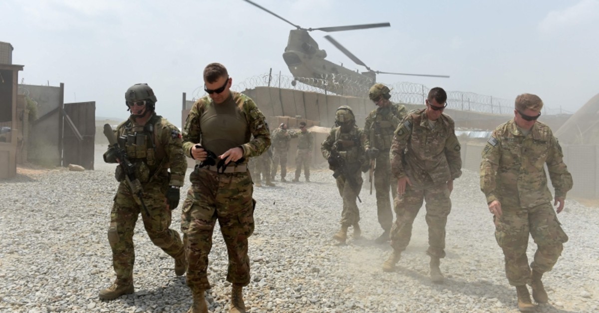 In this file photo taken on August 12, 2015 US army soldiers walk as a NATO helicopter flies overhead at coalition force Forward Operating Base (FOB) Connelly in the Khogyani district in the eastern province of Nangarhar. (AFP Photo)