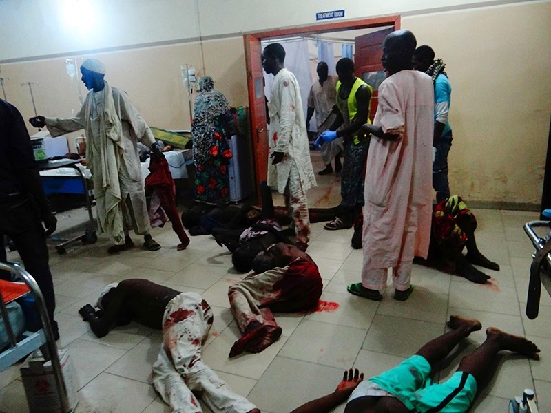Injured victims of a female suicide bomber lie on the floor awaiting medical attention as beds were no longer available at a Maiduguri hospital in northeastern Nigeria on August 15, 2017. (AFP Photo)