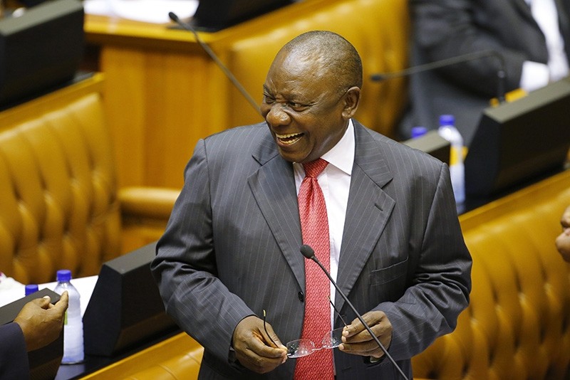 Acting President of South Africa Cyril Ramaphosa  smiles while he listens to a debate in Parliament in Cape Town, South Africa Feb. 15, 2018, prior to being sworn in (AP Photo)
