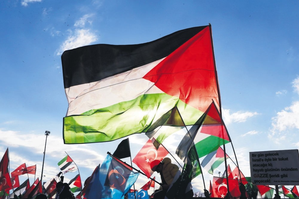 People wave the flags of Palestine and Turkey during a rally against President Trump's decision on Jerusalem, Istanbul, Dec. 17.