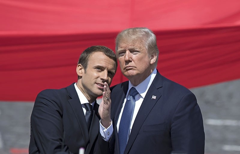This photo shows French President Emmanuel Macron (L) talking to US President Donald J. Trump (R)  while attending the traditional military parade as part of the Bastille Day celebrations in Paris, France, July 14,2017. (EPA Photo)