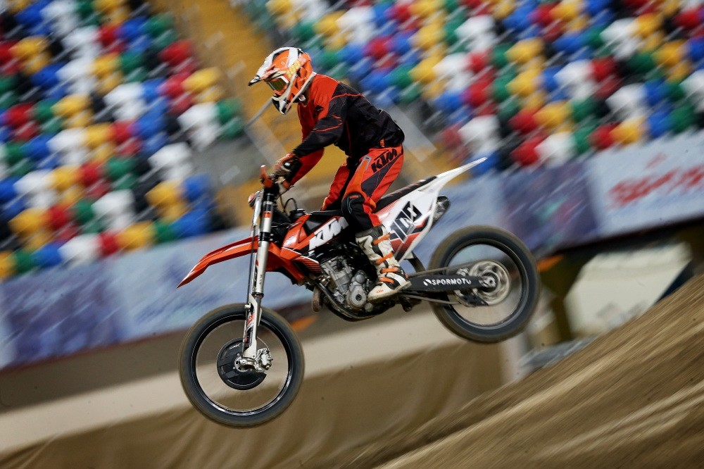 It took a month and nearly 350 truckloads of dirt to transform the indoor athletics facility into a motocross track.