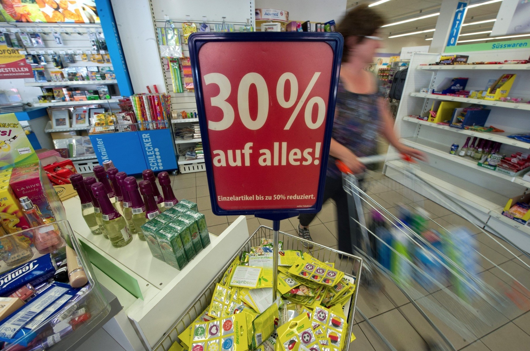 A woman pushes a shopping cart in a Schlecker XL store, Fellbach, Germany.