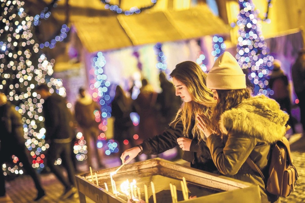 The faithful light candles at a Christmas Mass at the St. Anthony of Padua Church in Istanbul.