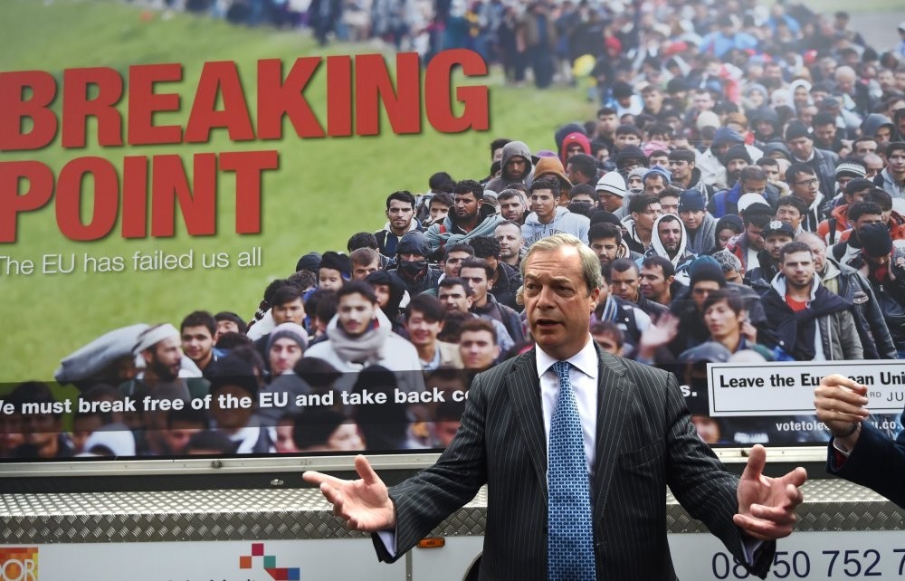 Former United Kingdom Independence Party (UKIP) member Nigel Farage poses in front of the official u201cleaveu201d campaign poster of his party, June 16, 2016.