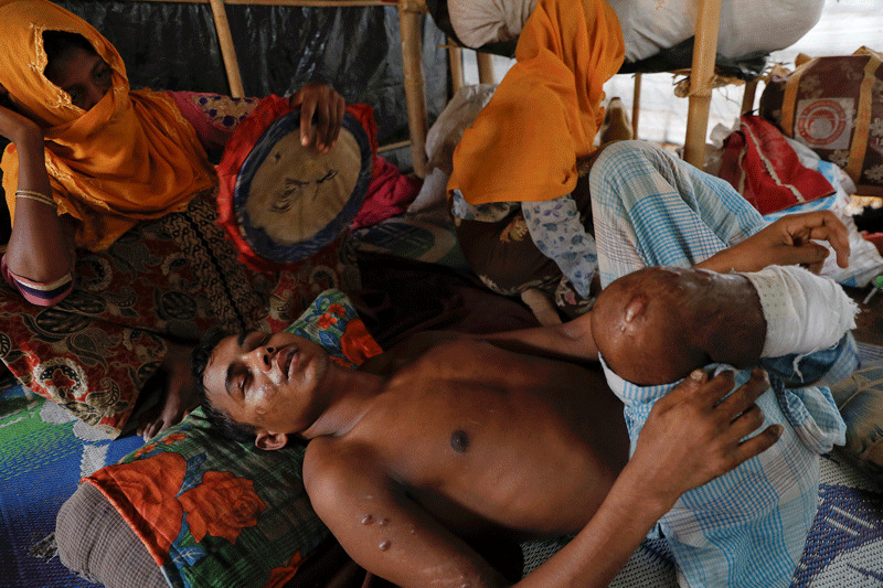 27-year-old Rohingya refugee and landmine victim, is comforted by his mother as he suffers in pain at his family's shelter at Kutupalong refugee camp near Cox's Bazar, Bangladesh (Reuters Photo)