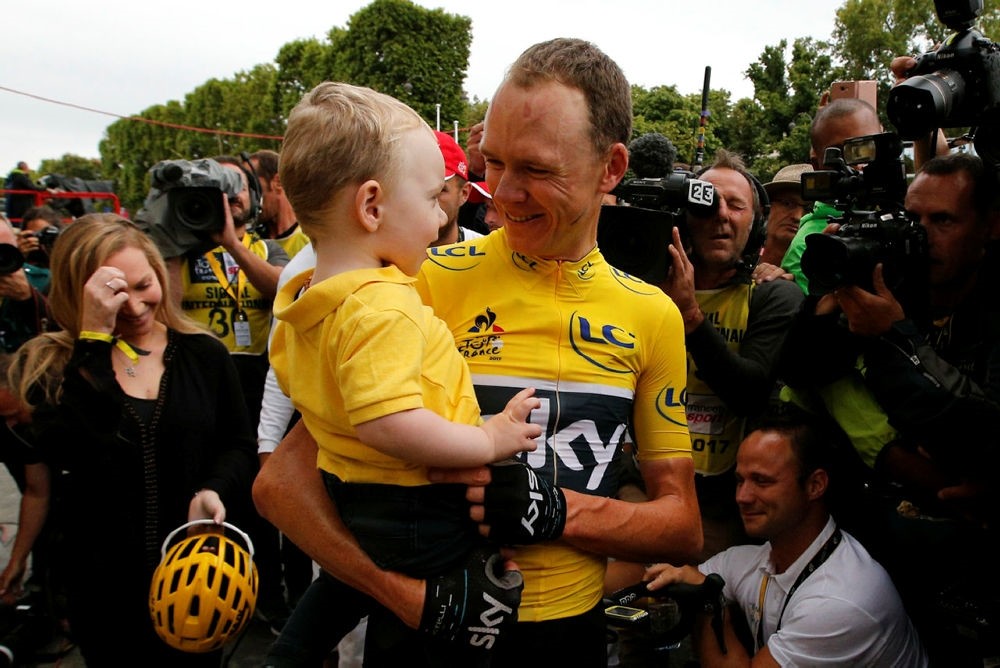 Tour de France winner Britain's Chris Froome holds son Kellan during the twenty-first and last stage of the Tour de France cycling race in Paris, France, Sunday, July 23, 2017. (AP Photo)