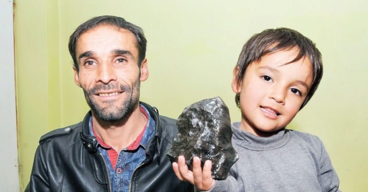 Hasan Beldek poses with his son holding a large meteorite he found in his village Saru0131u00e7iu00e7ek in this undated photo.