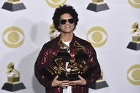 Bruno Mars poses in the press room with his awards for best R&B album, record of the year, album of the year, best engineered album, non-classical, song of the year, best R&B performance and best R&B song, at the 60th annual Grammy Awards (AP Photo)