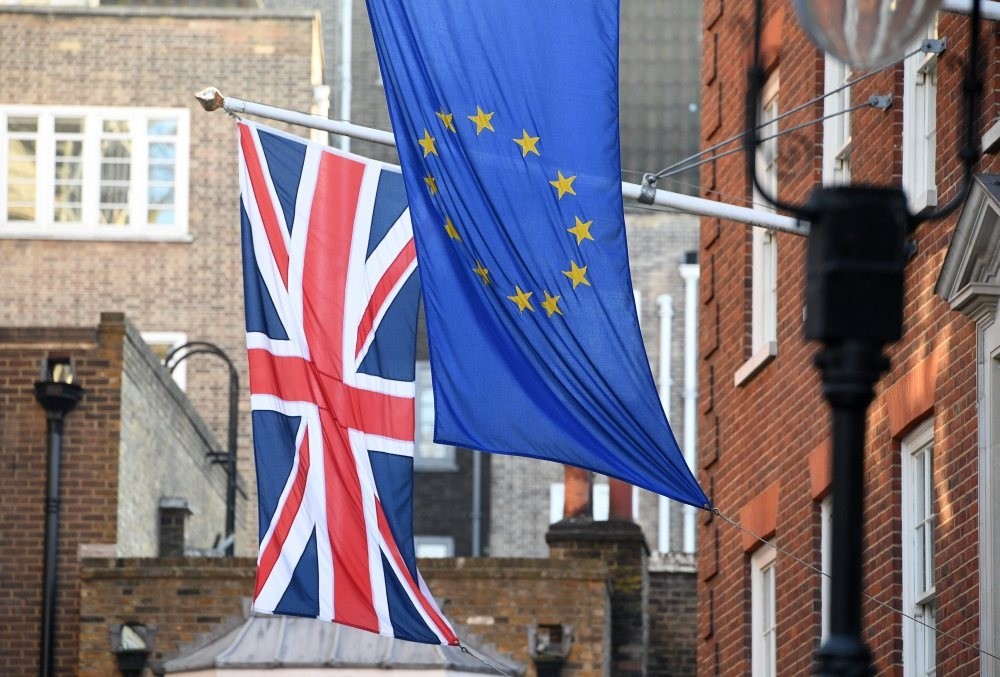 The EU and Union Jack flags fly side by side outside the Europa House in Westminster, London.