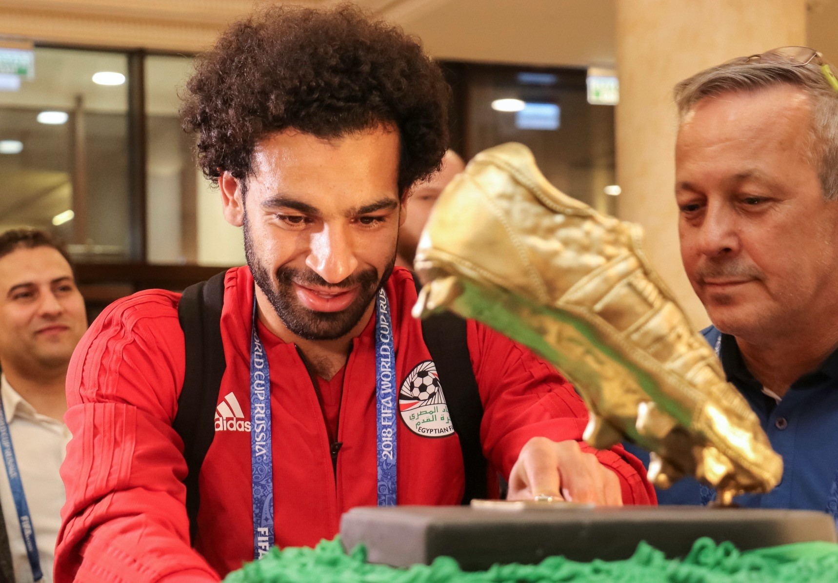 Egyptian national team player Mohamed Salah receives a cake, weighing 100 kilograms and decorated with a golden football boot, as a present on his birthday in the Chechen capital Grozny, June 16.