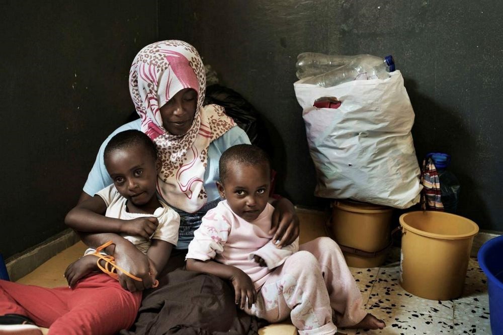 An Eritrean woman with her two daughter inside their cell at Alguaiha detention center for illegal migrants in Libya.