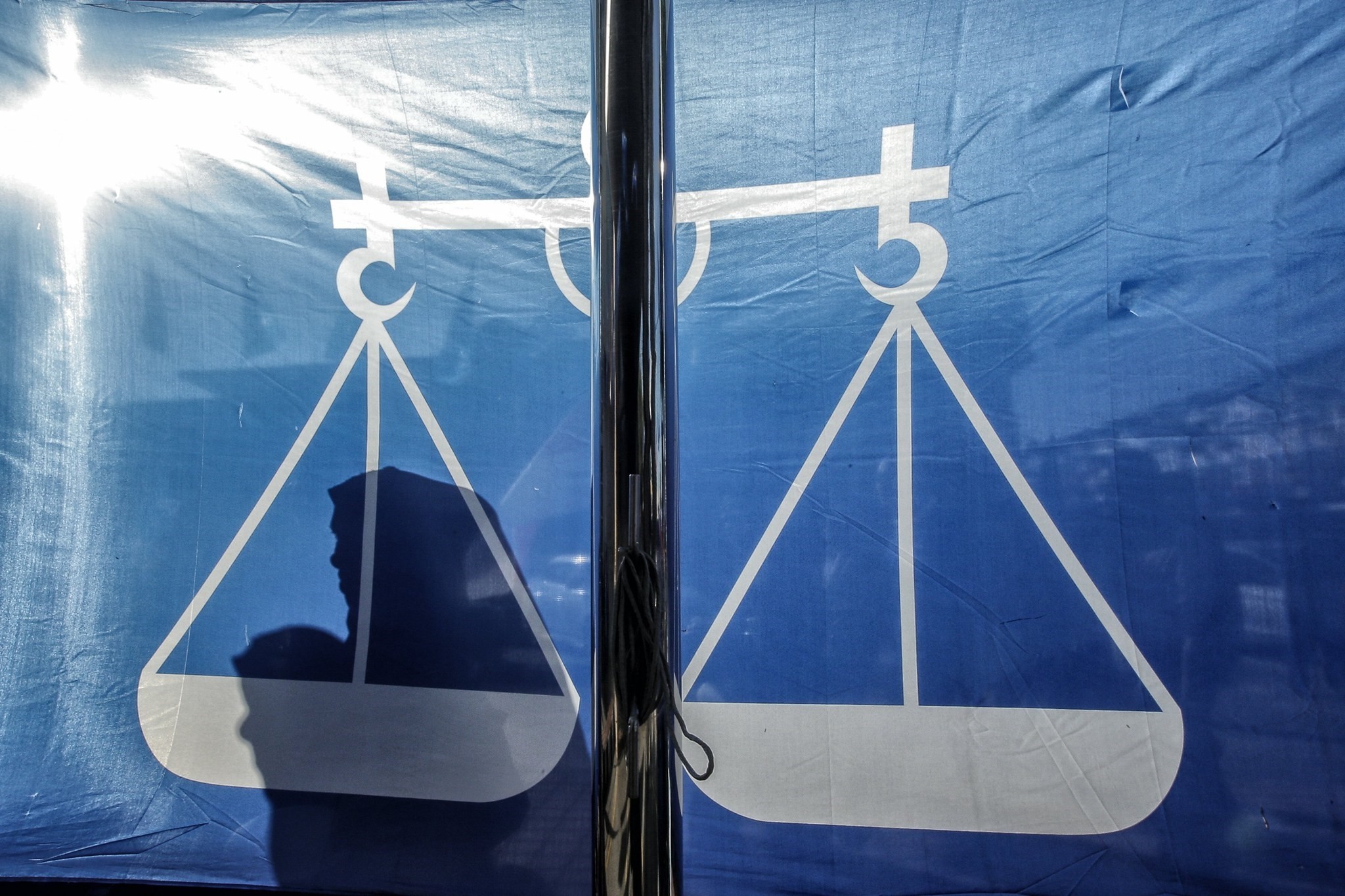 Shadows of supporters are cast on a flag of the National Front coalition (BN) party during the nomination day of the Malaysian 14th general elections, Pahang, 300 km outside Kuala Lumpur, Malaysia, April 28.
