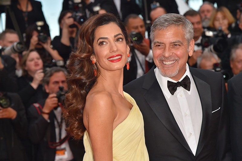 File photo dated May 12, 2016 shows US actor George Clooney (R) and his wife Amal Clooney at the 69th Cannes Film Festival in Cannes, southern France. (AFP Photo)