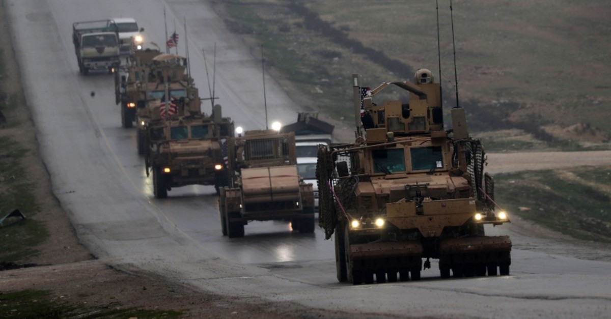 n this file photo taken on December 30, 2018 a convoy of US military vehicles rides in Syria's northern city of Manbij (AFP Photo)