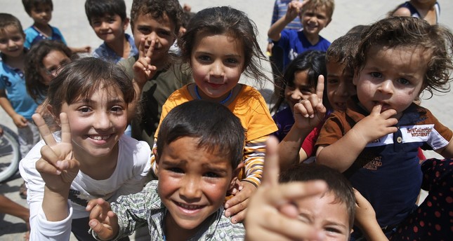 Children play at the Öncüpınar camp for Syrian refugees next to the border crossing with Syria, near Kilis in southeastern Turkey, June 20, 2016. (AP Photo)