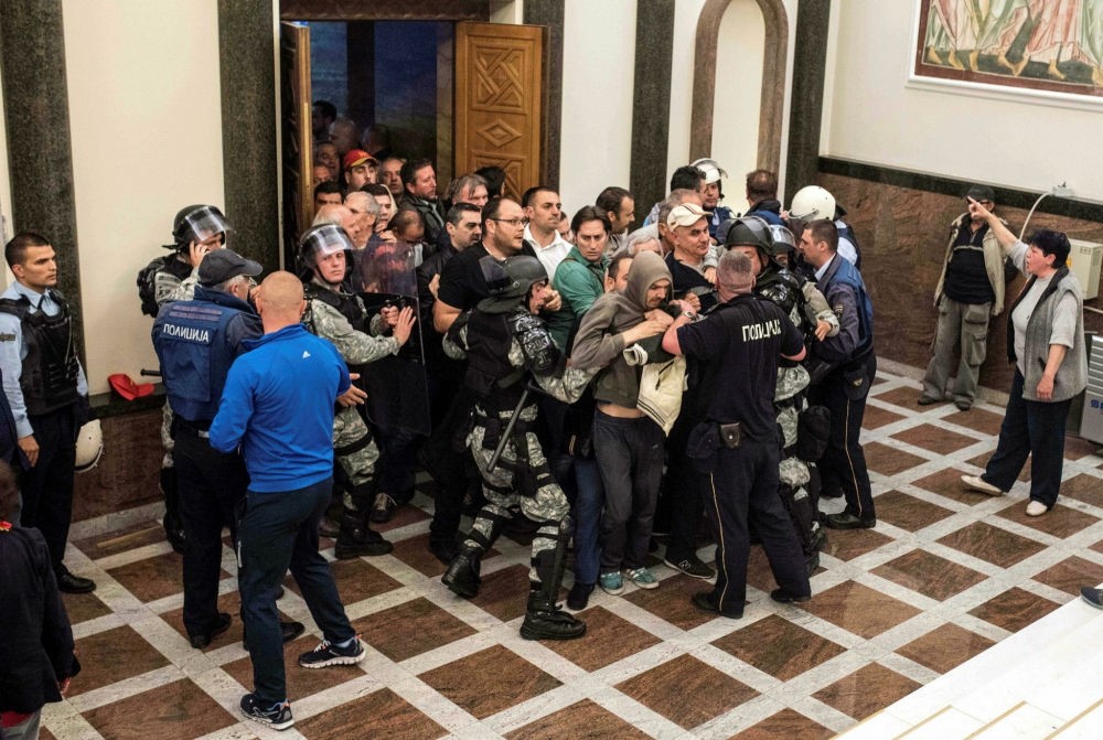 Policemen try to contain protesters trying to enter Macedonia's parliament in Skopje, on April 27. (AFP Photo)