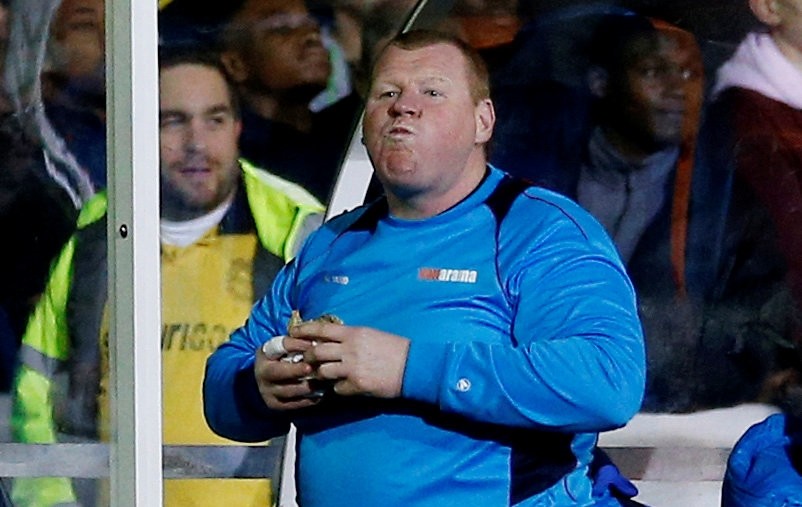 Sutton United's substitute Wayne Shaw eats a pie during the match. (REUTERS Photo) 