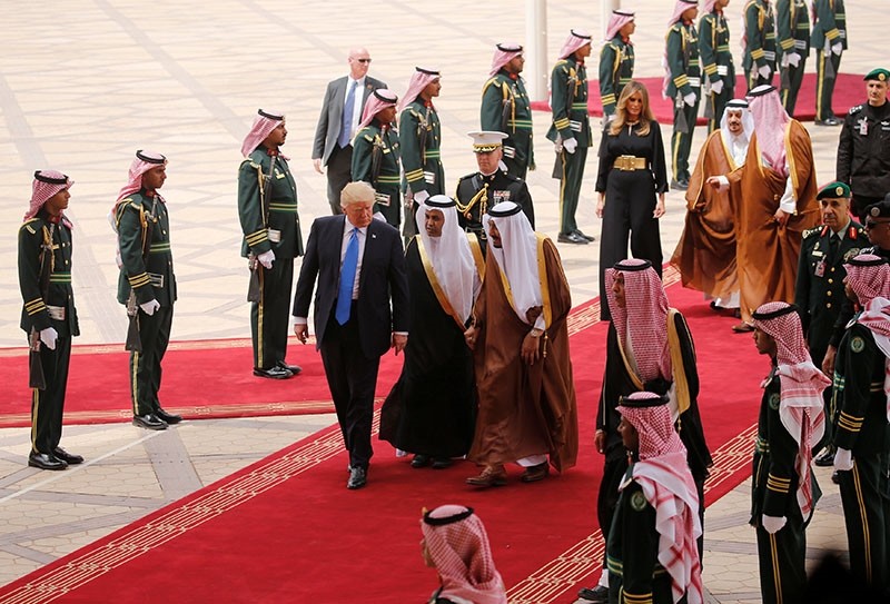 US President Donald Trump (C) is welcomed by Saudi King Salman bin Abdulaziz al-Saud (3rd-R) upon arrival at King Khalid International Airport in Riyadh. (AFP Photo)