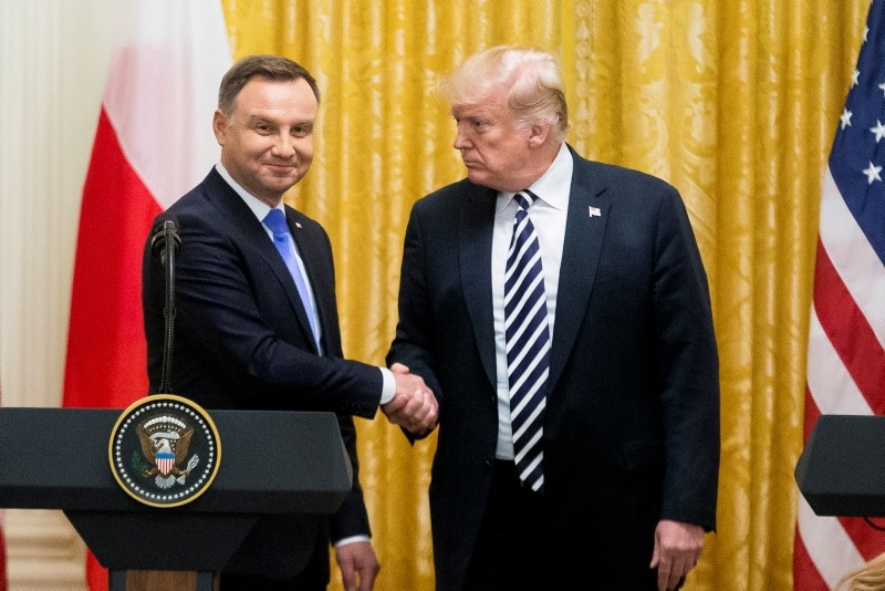 U.S. President Donald Trump, right, shakes hands with Polish President Andrzej Duda during a news conference in the East Room of the White House in Washington, Tuesday, Sept. 18, 2018. (AP Photo)