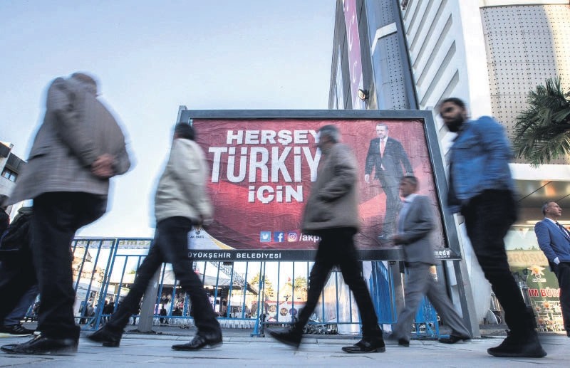 People walk by a billboard of President Recep Tayyip Erdou011fan that reads ,Everything for Turkey,, Van, Eastern Turkey, May 16. (EPA Photo)