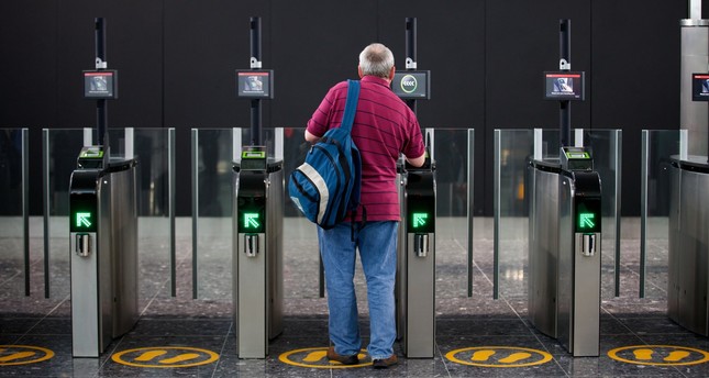 A passenger scans his boarding card in the new Terminal 2 at Heathrow Airport in London, Britain, 04 June 2014. (EPA Photo)
