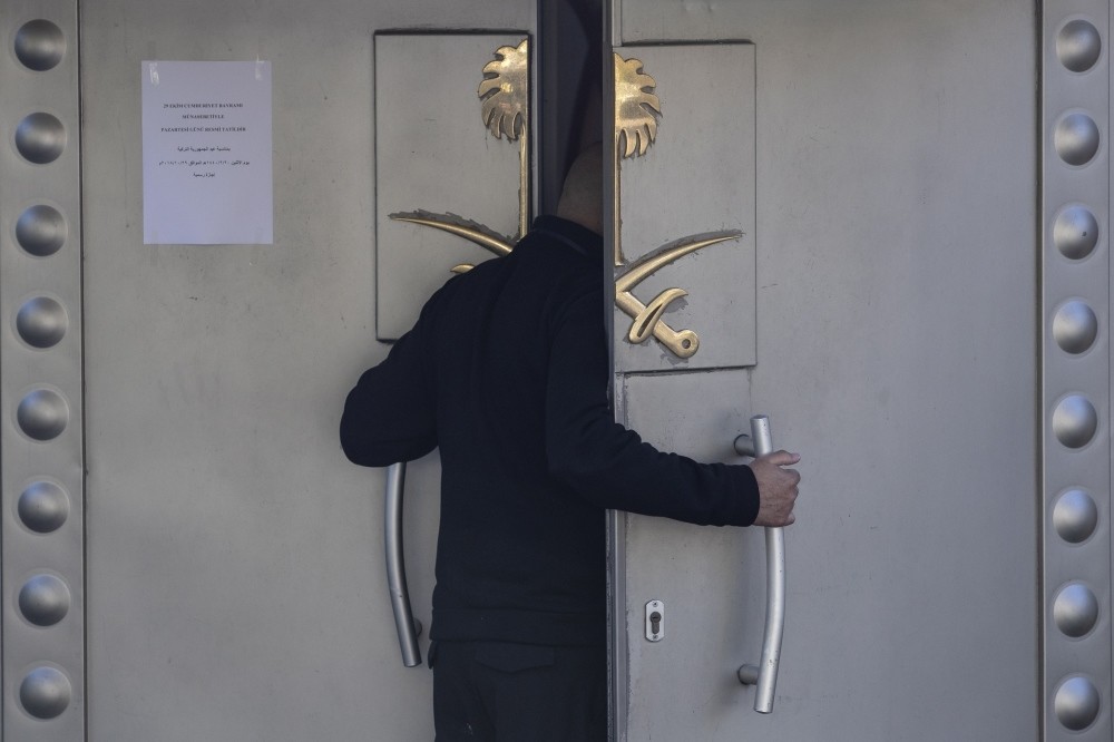 An official stands in front of the Saudi Consulate in Istanbul as members of the media gather outside to cover developments in the killing of the Saudi dissident and journalist Jamal Khashoggi, Oct. 29.