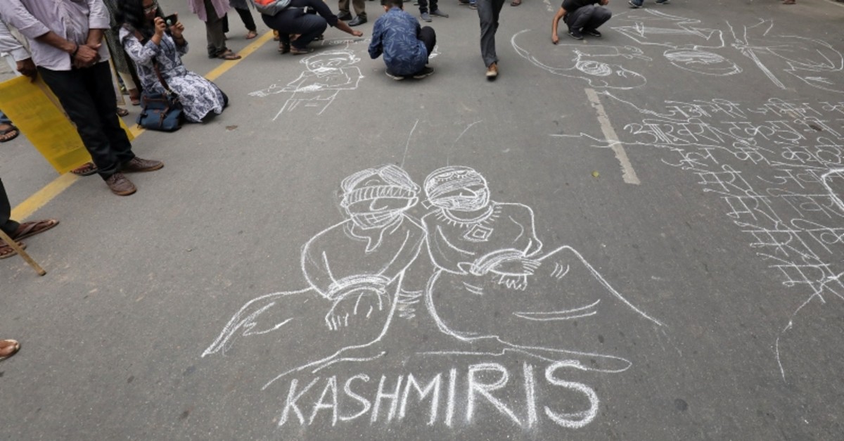 People draw and write messages on a road during a protest against the scrapping of the special constitutional status for Kashmir by the government, in New Delhi, India, Aug. 7, 2019. (Reuters Photo)