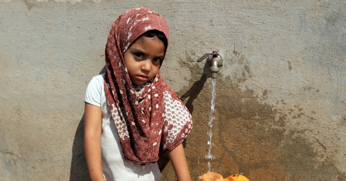 A girl fills a jerry can with drinking water, Hodeidah, March 25, 2019.