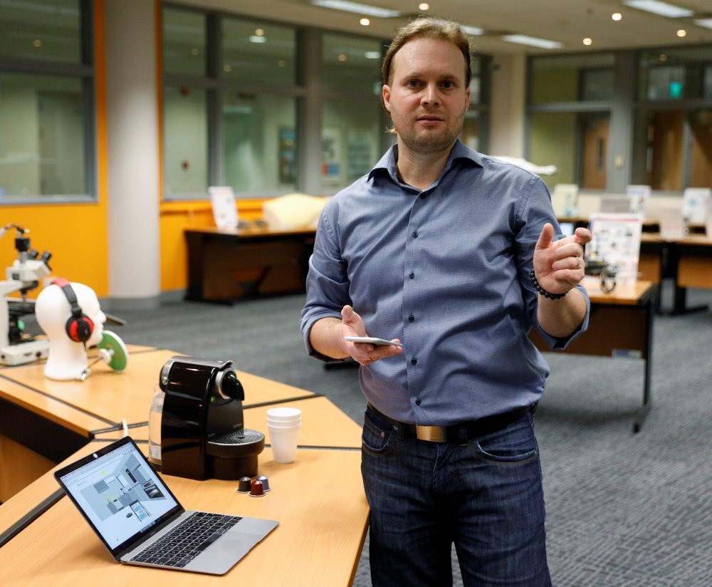 CEO of Unified Inbox Toby Ruckert demonstrates how he uses his smartphone to control electrical appliances in a simulation software in Singapore.