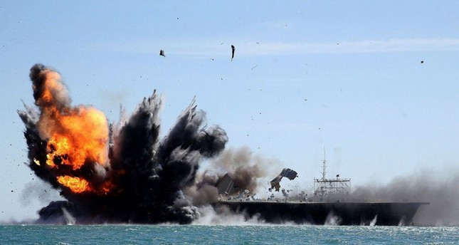 Iran's Revolutionary Guard troops attack a naval vessel during a military drill in the Strait of Hormuz.