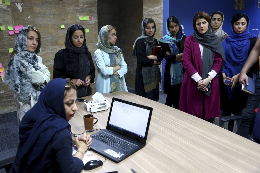 Employees of the Bamilo online shopping site attend a meeting at their office in Tehran.