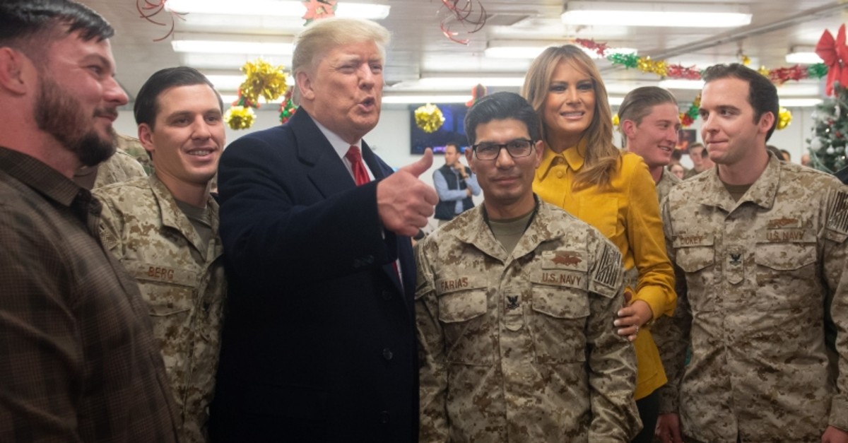 US President Donald Trump and First Lady Melania Trump greet members of the US military during an unannounced trip to Al Asad Air Base in Iraq on December 26, 2018. (AFP Photo)