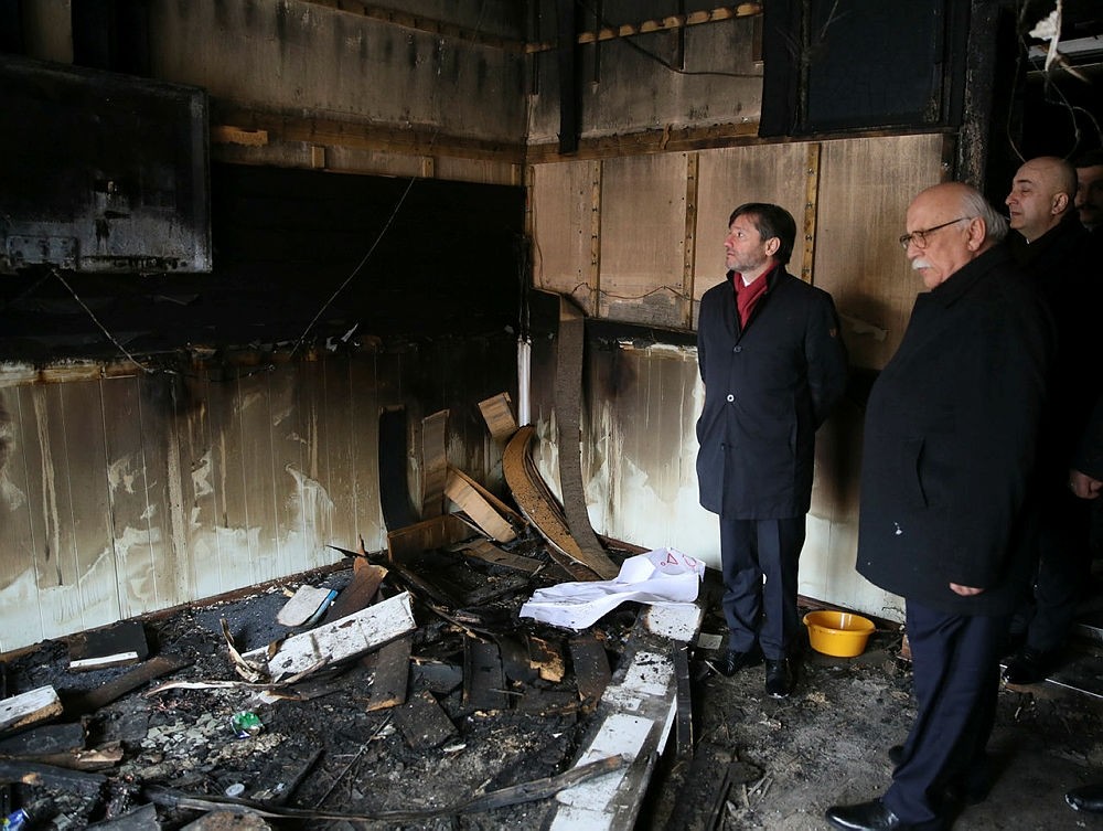 Former Tourism Minister and AK Party Deputy Nabi Avcu0131 inspects a scene of fire at Koca Sinan mosque in Berlin, Germany. (AA Photo)