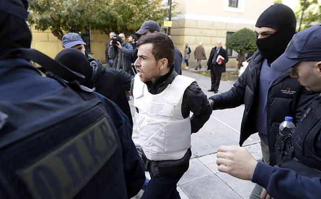 A Turkish suspect, no name available, is escorted by anti-terror police as he arrives at a court to face terrorism charges in Athens, Monday, Dec. 4, 2017. (AP Photo)